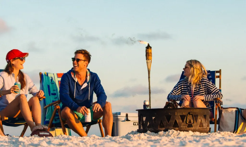 Friends enjoying a bonfire on the beach