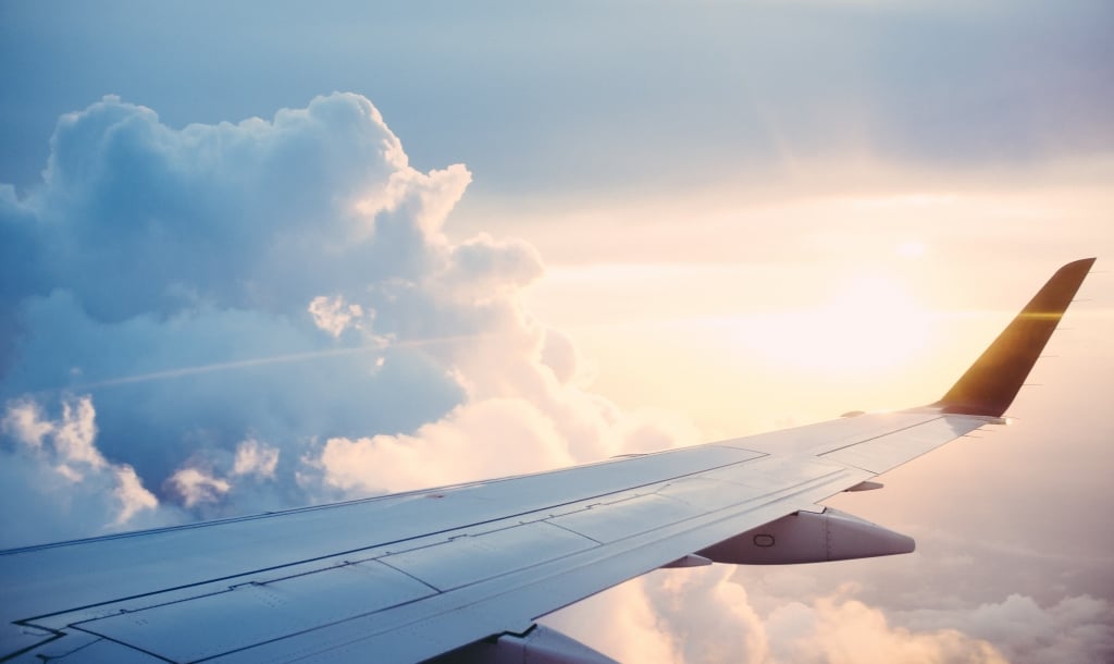 view out an airplane window, looking at the clouds