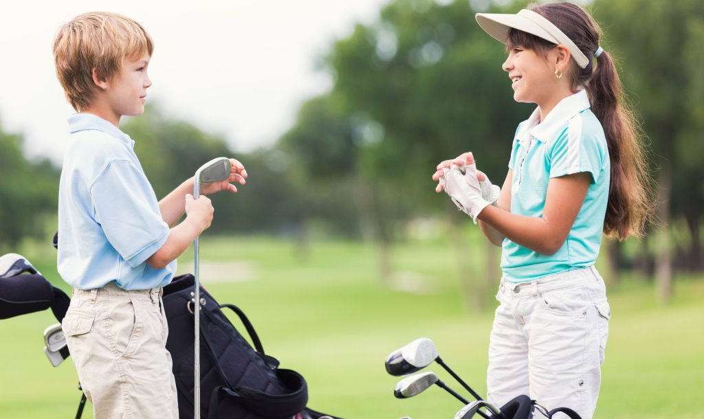 boy and girl playing golf