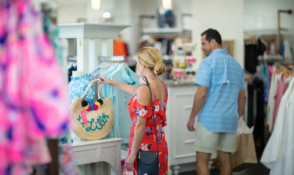 woman looking at a handbag that is for sale at Barefoot Princess