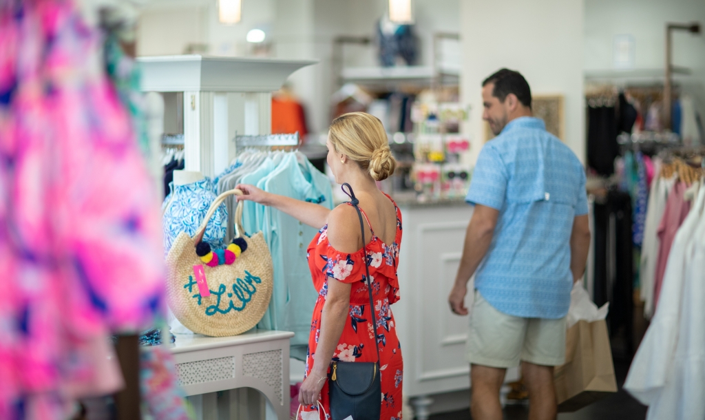 woman looking at a handbag that is for sale at Barefoot Princess