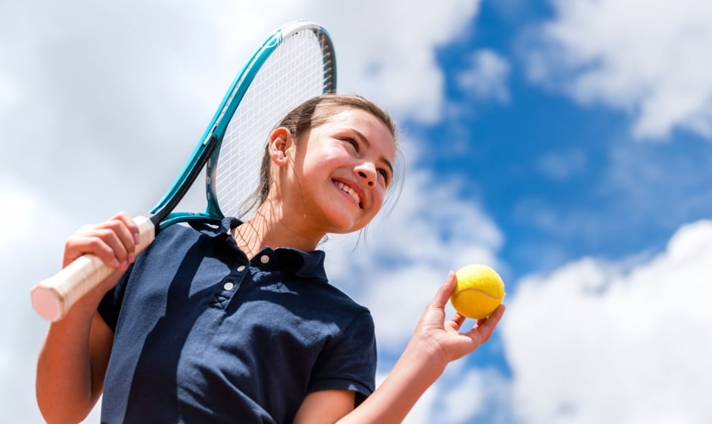 child playing tennis