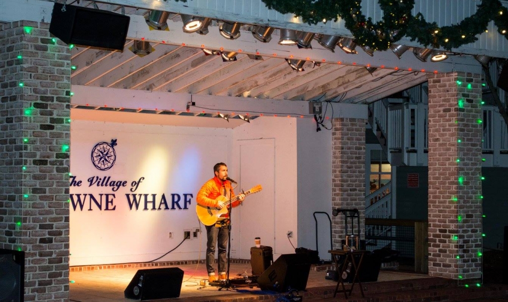 Man singing and playing guitar on the stage at Sandestin Golf and Beach Resort