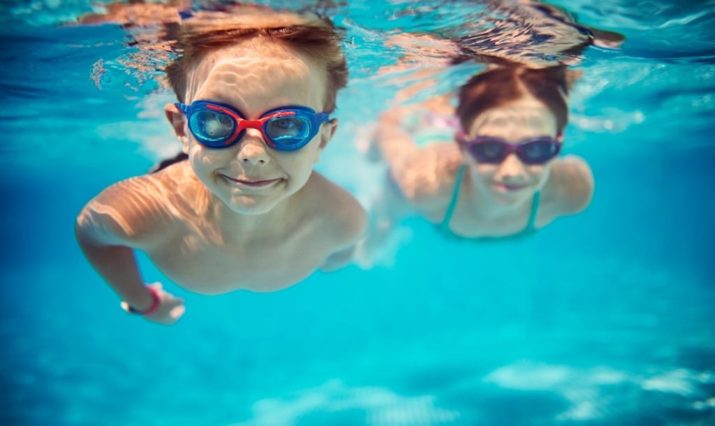 two kids swimming underwater