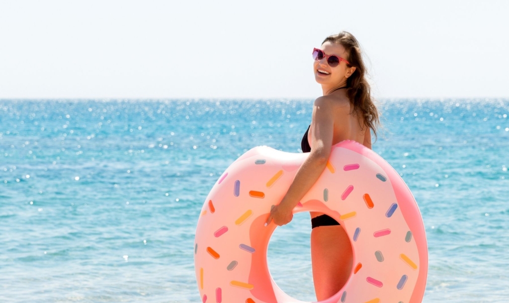 Woman holding a float on the beach