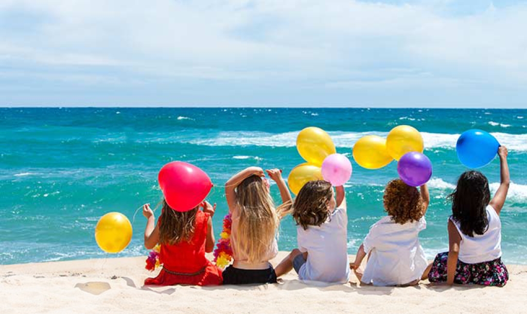 Kids on beach with balloons