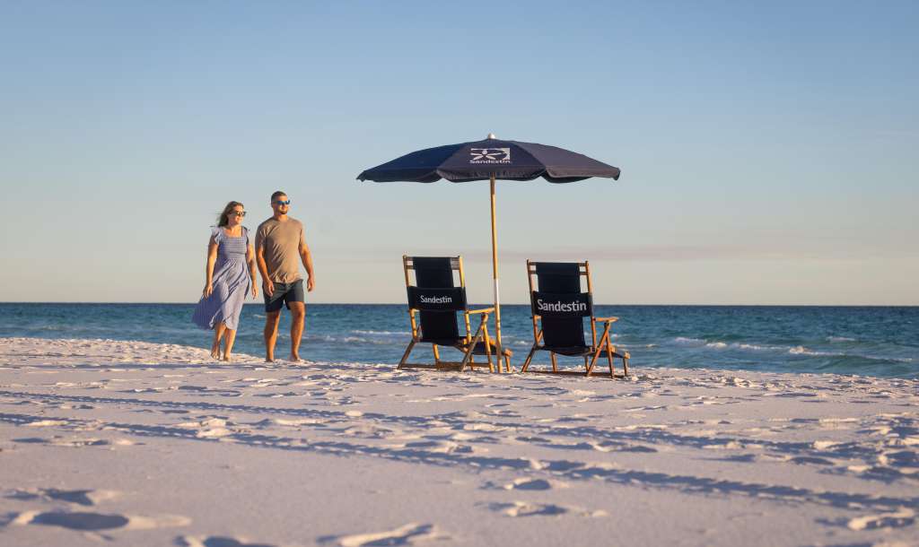Couple walking along the sugar white sands of Sandestin Golf and Beach Resort 