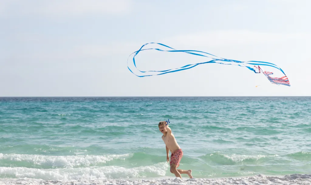 Child on a beach with a kite