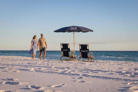 Couple walking along the sugar white sands of Sandestin Golf and Beach Resort 
