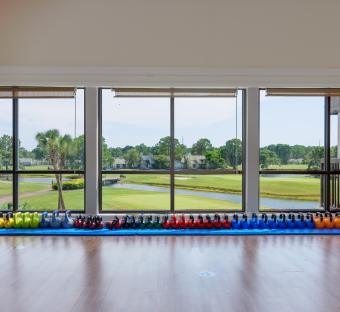 weights in front of a window overlooking the golf course