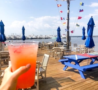 a frozen drink with the patio of Marina Bar & Grill in the background