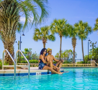 Couple relaxing at the edge of a pool