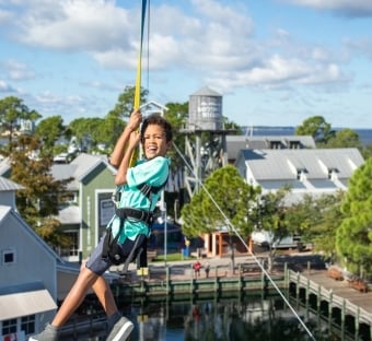 Kid zip lining at Baytowne
