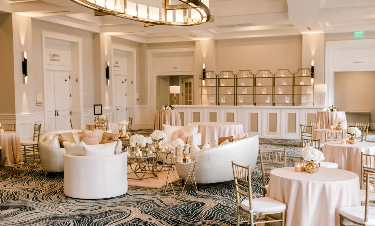 Azalea Ballroom set up for a wedding with white tables and chairs