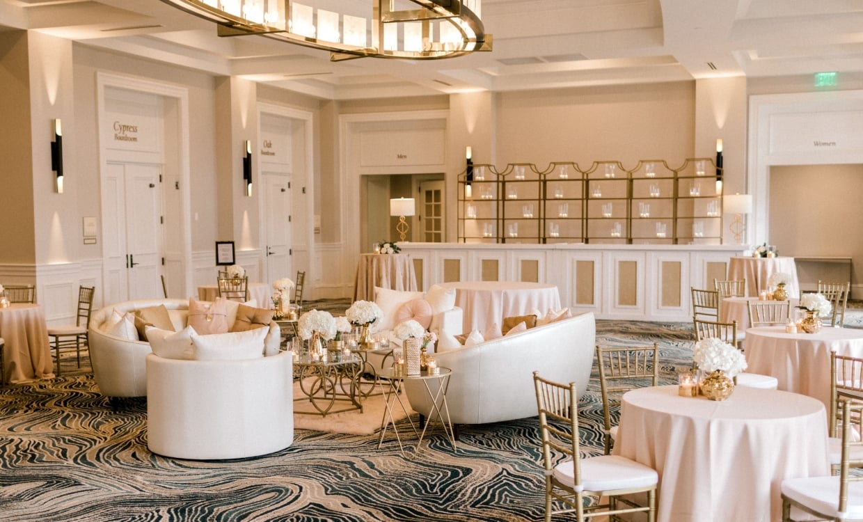 Azalea Ballroom set up for a wedding with white tables and chairs