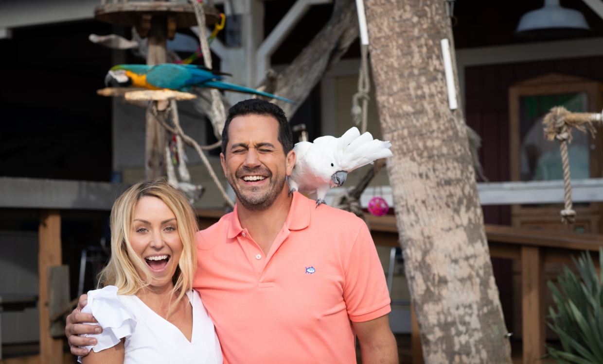 Man and woman with bird on their shoulder