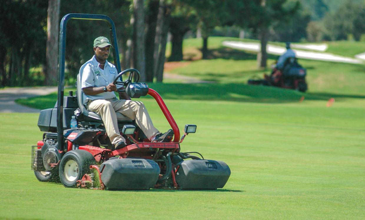 Sandestin Golf and Beach resort employee cutting the golf greens