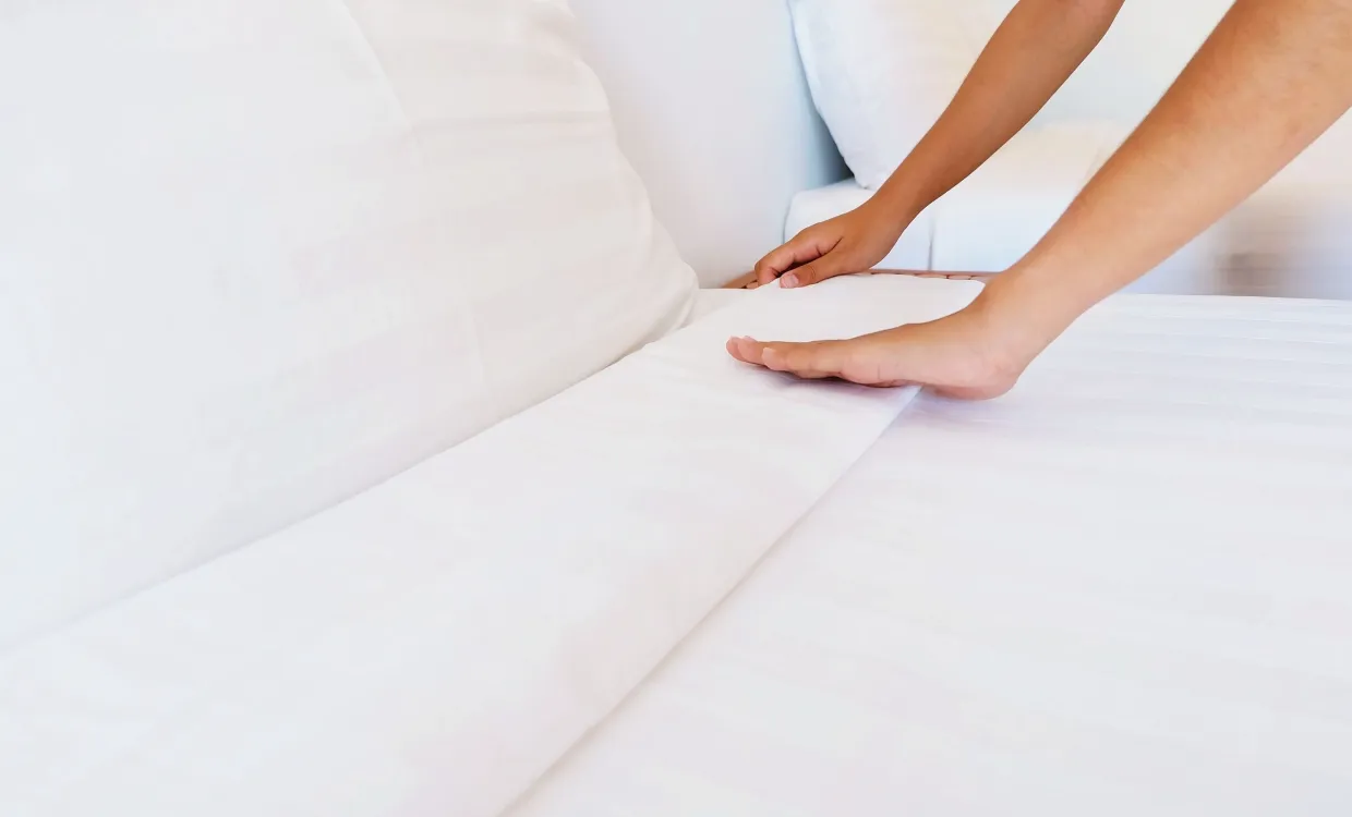 person making a bed