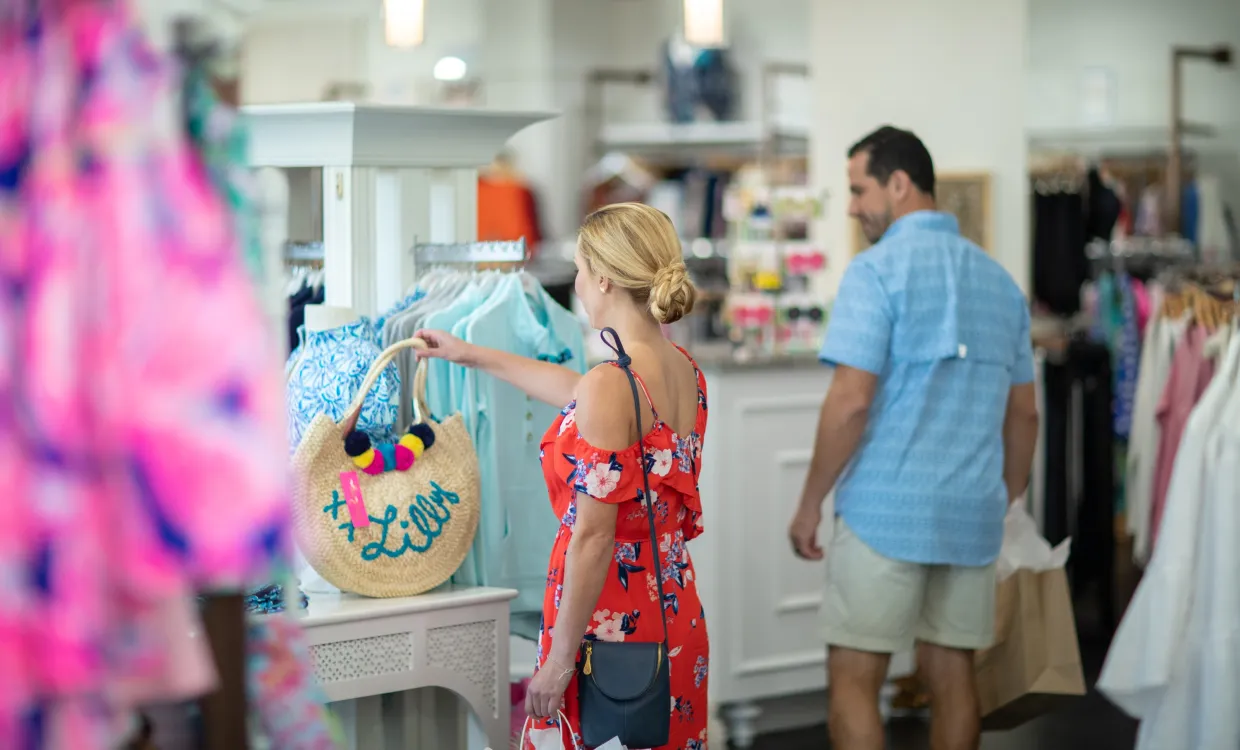 woman looking at a handbag that is for sale at Barefoot Princess