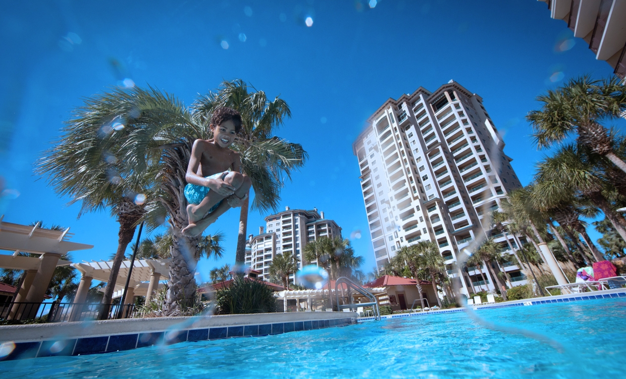 Kid Jumping into pool blue