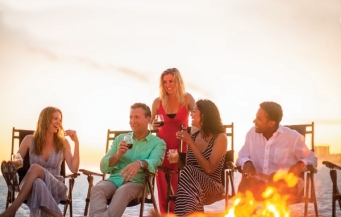 group having a bonfire on the beach